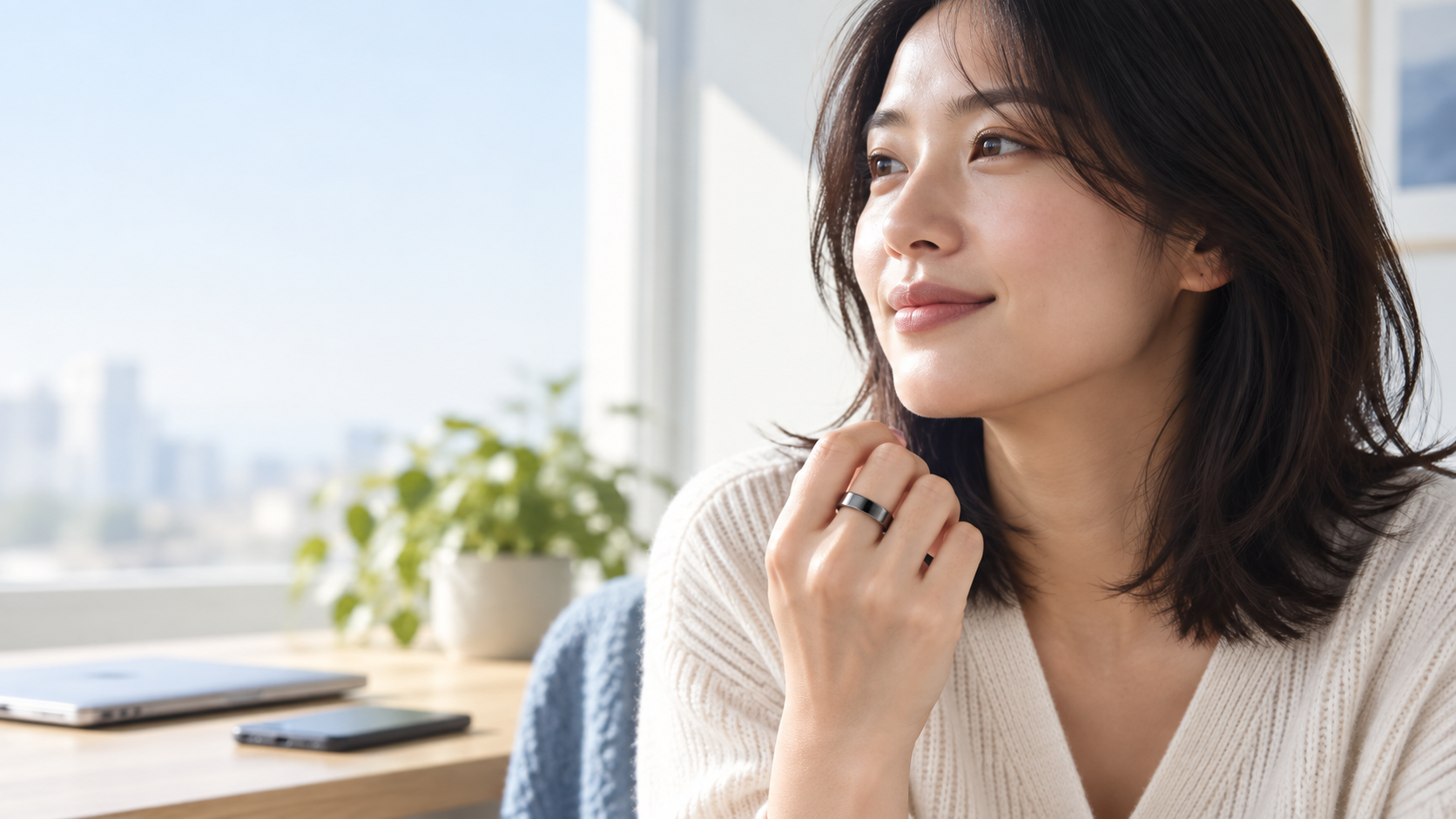 A Japanese woman wearing a black smart ring near a bright window
